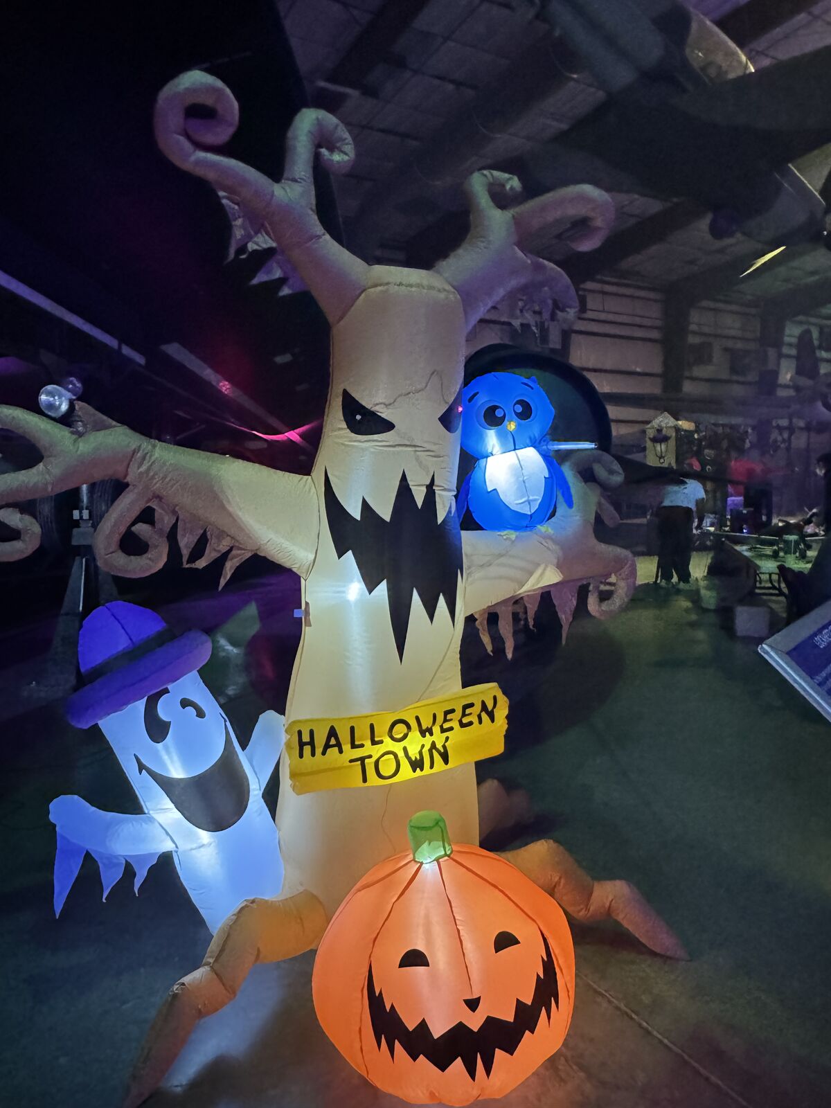 Glowing inflatable Halloween tree, ghost, and pumpkin