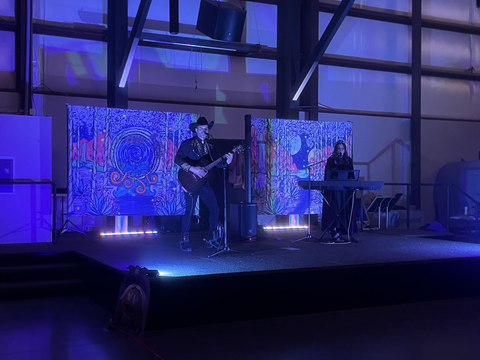 Musicians performing on stage in the hangar
